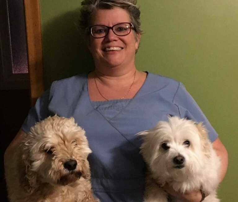 Lisa Clifford holding two dogs