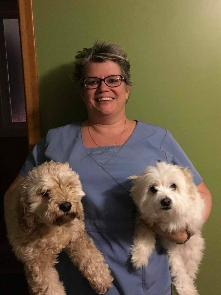 Lisa Clifford holding two dogs